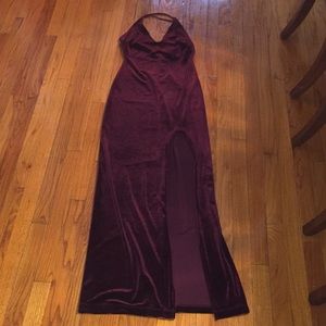 Tight fitting long red velvet dress with slit